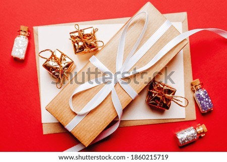 Christmas gift with toy on red isolated background. New Year concept