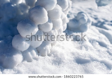 Snowballs lie on the snow. Children's winter games. Background