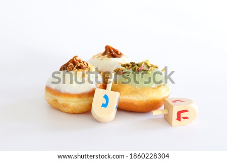 Banner of jewish holiday Hanukkah with doughnut and wooden dreidels (spinning top)