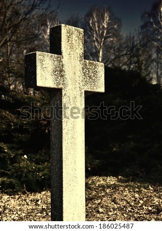 The cross on the grave of an unknown person. Abandoned cemetery.