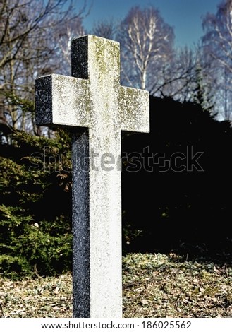 The cross on the grave of an unknown person. Abandoned cemetery.