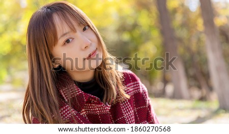 Beautiful Asian women in the park in autumn