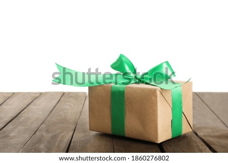 Christmas gift on wooden table against white background