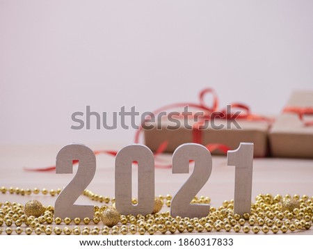 New year 2021 white wood number on golden christmas decorations at blur background