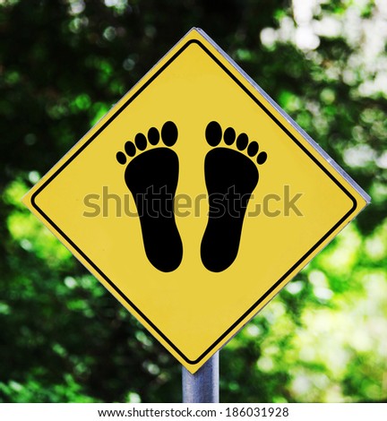Yellow road sign outdoor with footprint pictogram