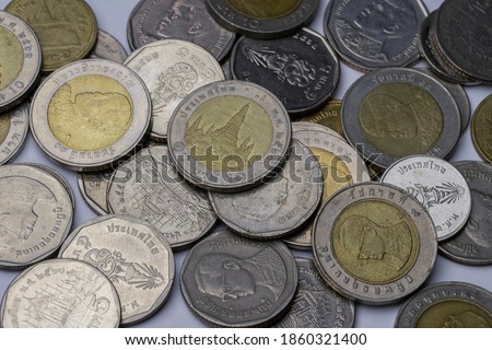 group of various Thai bath coins (1, 2, 5 and 10 THB)  random spread on white background Royalty-Free Stock Photo #1860321400