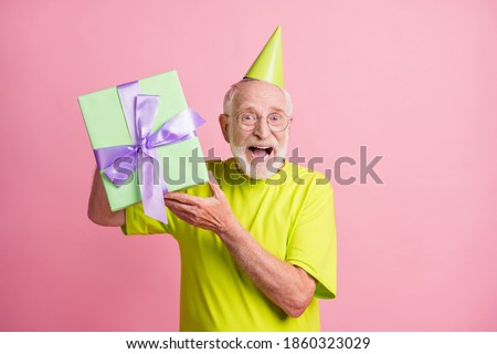 Photo of funky old man present gift wear birthday hat spectacles green color clothes isolated on pink background