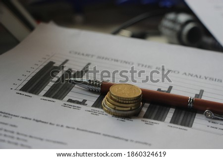 Graph chart financial report documents, euro coins and pen. Financial data analysis business concept, counting every cent and saving money concept.