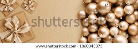 merry christmas, top view of wrapped gift present packages and champagne color balls, isolated on beige background, useful as a greeting gift card