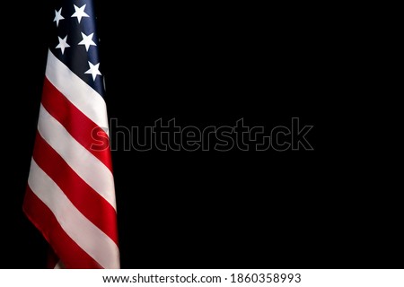 Closeup of American flag on dark black background. Flyer.