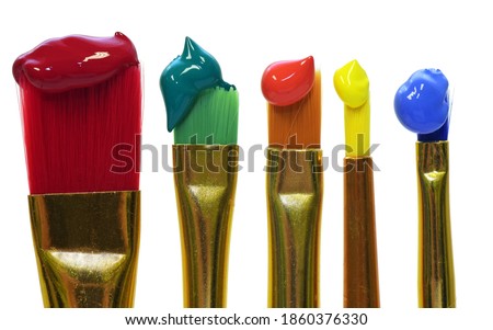 Colorful paintbrushes are placed vertically next to each other and each has color at the tip, against a white background Royalty-Free Stock Photo #1860376330