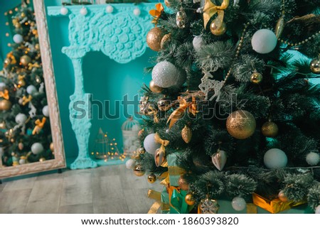 Christmas tree with gold and white balls in a turquoise interior. with gifts. Festive decoration. New year background