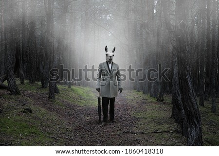 Mystical picture of a strange creature with a human body and a guanaco head in a mysterious forest covered with fog Royalty-Free Stock Photo #1860418318