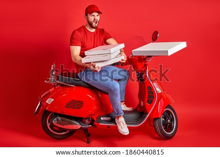 caucasian angry delivery man has no time to delay delivery of orders, young male in uniform sits on motorcycle and throw boxes with pizza in the side