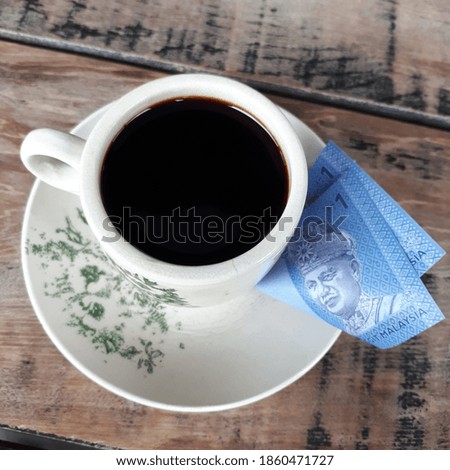 Coffee cup and money - vintage style effect picture

