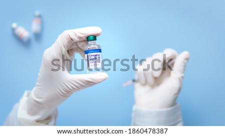 Potential vaccine for COVID-19 in clinical trials stage phase 3 concept. Hand of a Researcher holding Coronavirus 2019-nCoV vial ready to test with volunteer to proven it's safe and effective. FDA