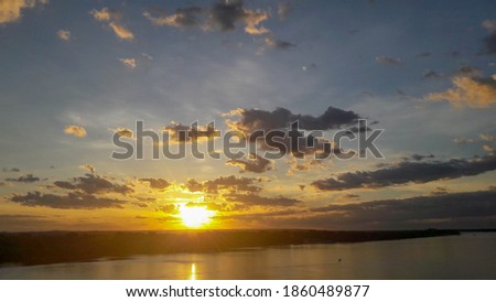 River and Amazon rainforest with slightly cloudy sky at sunset in northwest photo