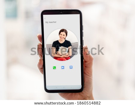 Woman hand with smartphone during distant lesson