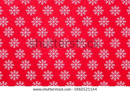 White snow flakes decorated on red background. Flat lay christmas decoration