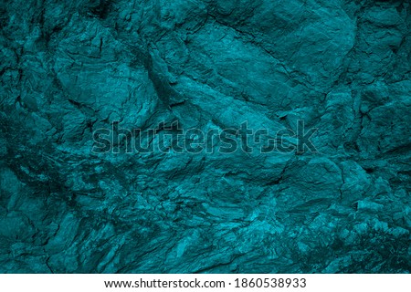    Blue green grunge background. Toned rock texture background. Combination of teal color and rough cracked stone surface. Tidewater Green color abstract background.                             Royalty-Free Stock Photo #1860538933