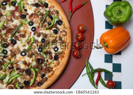 A delicious pizza with mushroom and green peppers.