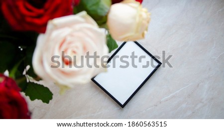 Greeting, post card, photo frame mock up on marble background with the bouquet of roses