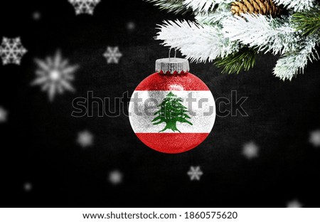 Happy new Year 2021, flag of Lebanon on a christmas toy, decorations isolated on dark background. Creative christmas concept.