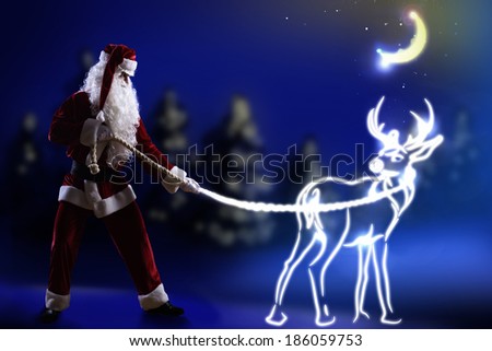 Santa claus looking at magic image of deer