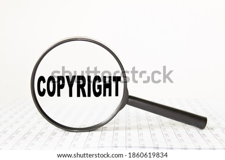 words COPYRIGHT n a magnifying glass on a white background. business concept