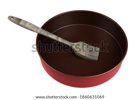 Non-stick cake pan and silicone brush isolated on white background