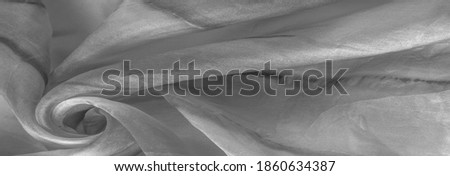 Black and white fabric with streaks of gray spots on a white background. Abstract designer fabric fancy designer. Beautiful background for your design. Texture. Picture. drawing, pattern, figure