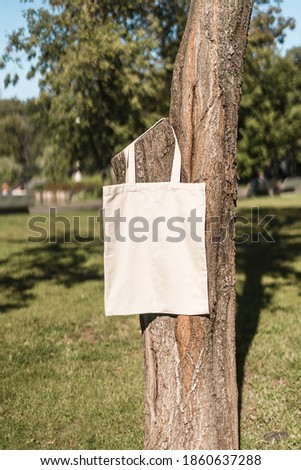 Beige tote bag on the tree