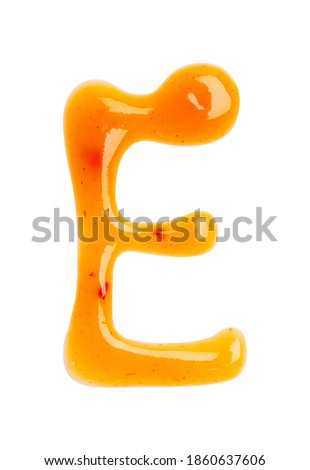 Chili sauce alphabet Letter E isolated on a white background. Close up, top view.
