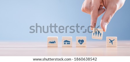 Wooden blocks with icons of various types of insurance. Life insurance concept. Royalty-Free Stock Photo #1860638542