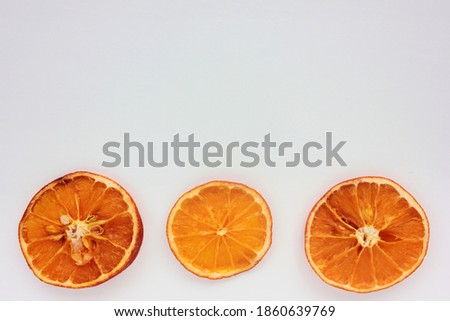 Dried oranges on white background. Flat lay Christmas border. Copy space