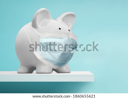 Cute piggy bank, wearing a protective face mask Royalty-Free Stock Photo #1860655621