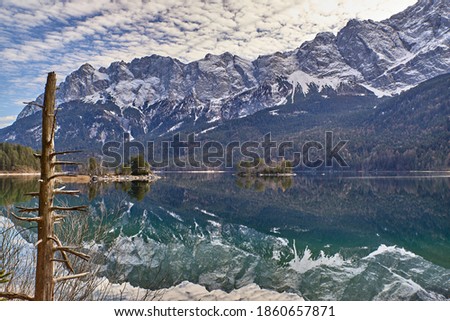 Zugspitze reflecting in the Eibsee. Reflecting mountain lake in the german alps. Turquoise mountain lake in bavaria. Eibsee and Zugspitze in the background.