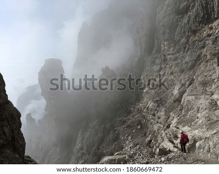 hiker struggling on a trail in the Dolomites Italy 