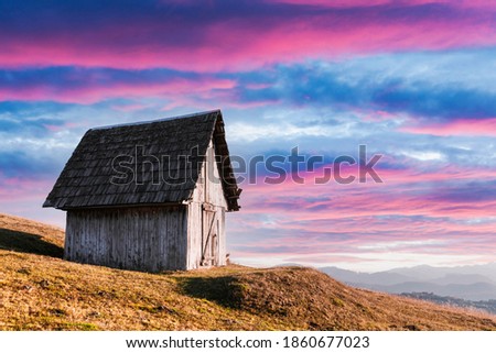 Picturesque autumn meadow with old wooden house and clear sky in the Carpathian mountains, Ukraine. Landscape photography