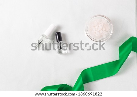 Translucent colorless nail polishes isolated on white background. Modern cosmetic products. flat lay, copy space. Nail work flat lay concept. Image for beauty salons Royalty-Free Stock Photo #1860691822