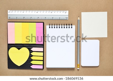 Note paper post it with stationary objects on brown background
