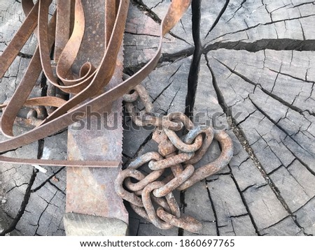Scrapped saw and rusty chain