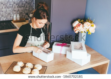 Young woman cooking on home kithen. Preparation pastry dessert. Homemade pastry. Small business
