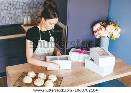 Young woman cooking on home kithen. Preparation pastry dessert. Homemade pastry. Small business
