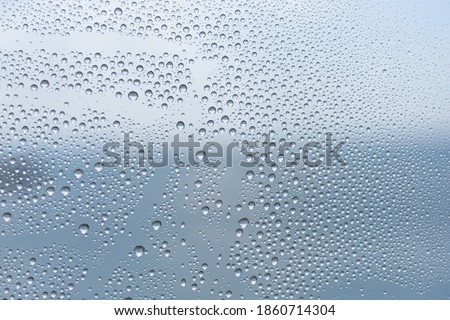 Closeup water droplets on frosted glass thick film for reduces visibility across. Toilet wall sticker bathroom decoration. Office films privacy for bathroom Office meeting room.