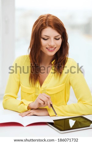 business, education and technology concept - smiling student with tablet pc computer and notebook in college