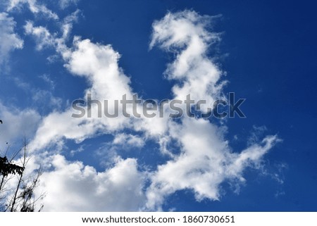 monster like white clouds in clear blue sky background