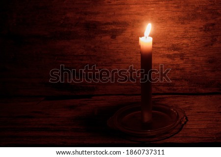Candlelight in a room in a dark, traditional rural house. Rustic and romantic background concept.