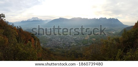 Image of the Swiss town of Aigle featuring the imposing Swiss Alps and les dents du midi in the background, Outer Leysin, Vaud, Switzerland 