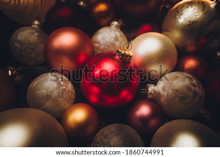 Christmas ornaments on puffy blanket. Cozy Christmas picture. Moody images celebrating for Christmas. Winter holiday golden light captures.